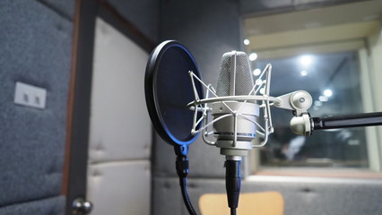 Sound production recording studio with microphone and shock mount and pop filter on tripod which use for vocalist or narrator or dj on brodcasting or professional creator live online channel 