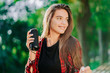 © kohanova1991 - Modern trendy girl listening to music by wireless portable speaker.Young beautiful american woman enjoying,dancing in park.