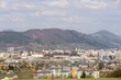 Sunrise and sunset, beautiful clouds over the meadow, hills and buildings in the town. Slovakia