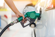 Man Refill And Filling Oil Gas Fuel At Station.Gas Station - Refueling.To Fill The Machine With Fuel. Car Fill With Gasoline At A Gas Station. Gas Station Pump. 