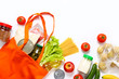 Set of grocery items from vegetables, canned food, pasta, oil, cereal in eco shopping bag on white background. Top view.