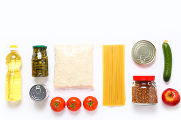 Wall Mural - Food supplies for the period of quarantine on white background. Set of grocery items from canned food, vegetables, pasta, cereal. Food delivery concept. Donation concept. Top view.