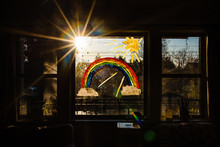 Rainbow With Sun And Clouds On Window For Encouragement During Pandemic