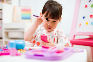 Wall Mural - toddler girl pretend play make up at home