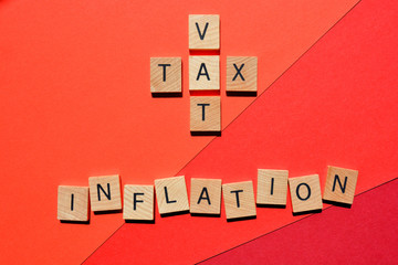 Wall Mural - VAT and Tax in crossword form with the word Inflation on red background