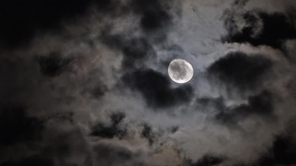 Wall Mural - full moon moving between clouds