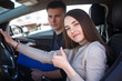 © Kobrinphoto - Driving instructor and woman student in examination car.