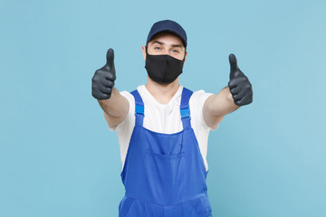 Wall Mural - Delivery man in cap t-shirt coveralls uniform sterile face mask gloves isolated on blue background studio. Guy employee courier Service quarantine pandemic coronavirus virus covid-19 2019-ncov concept