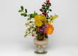 bouquet of spring colored flowers in a vase on a light background