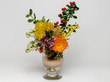 bouquet of colorful spring flowers in a vase on a bright background