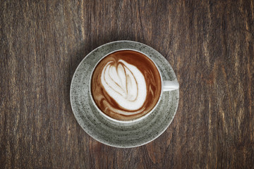 Wall Mural - A cup of coffee with latte art on top