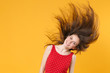 © ViDi Studio - Smiling young brunette woman girl in red summer dress posing isolated on yellow wall background studio portrait. People lifestyle concept. Mock up copy space. Having fun, jump with fluttering hair.