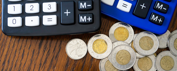 Blue and Black Calculator with Canadian Dollar coins