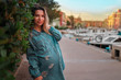 © Bas - Young pregnant girl in harbor with lot of yachts