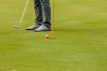 Playing golf on the green and during training