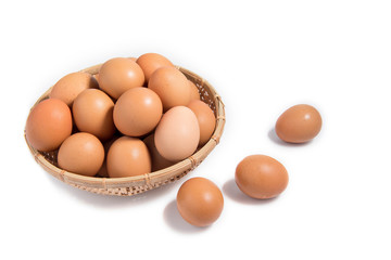 Eggs in a wooden basket on a white background.