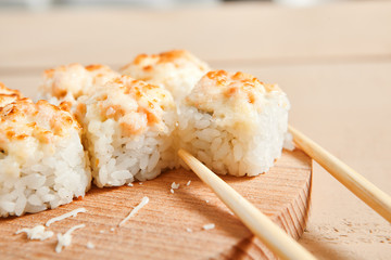 Canvas Print - Baked shrimp rolls on wooden board top view