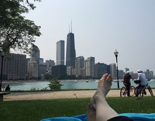 Low Section Of Person In Park Against City Skyline