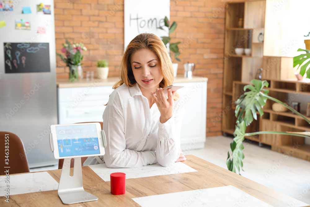 Woman using application of smart home automation