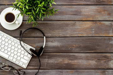 Poster - Office workplace. Headphones, computer keyboard on wooden background top view copy space