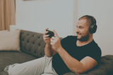 Fototapeta Krajobraz - man listening to music with headphones