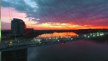 Runner Crossing Bridge Over River During Colorful Midwest Sunrise