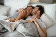 © JustLife - Young loving couple in bed. Top view of happy couple relaxing in bed.