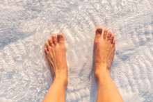 Barefoot Standing Over White Limestone Textured With Water In Pamukkale, Turkey