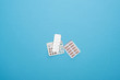 top view of pills in blister packs on blue background