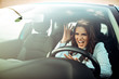 © Dragana Gordic - Woman is driving her car very aggressive and gives gesture with her fist. Angry female driver. Negative human emotions face expression. Furious woman stucked in traffic jam