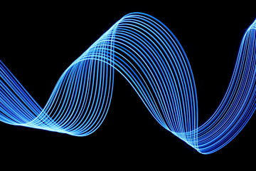 Wall Mural - Long exposure photograph of neon electric blue colour in an abstract swirl, parallel lines pattern against a black background. Light painting photography.