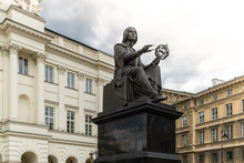 Nicolaus Copernicus Monument In Warsaw, Poland, Bronze Statue Of A Polish Astronomer From 1830, On Background Of Old Buildings