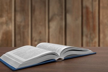 Wall Mural - open book on old wooden table.