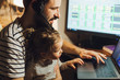 © Ananass - Stylish Bearded father working at home while babysitting his playful daughter