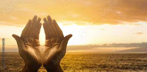 Fotografía Hands together praying in bright sky