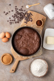 Fototapeta  - Ready brownie, chocolate cake in a detachable round shape. Top view, recipe, ingredients.