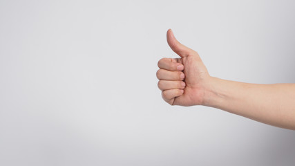 Wall Mural - Right hand is doing thumbs up sign on white background.