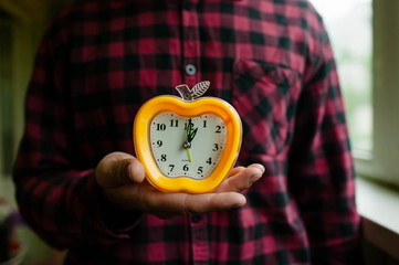 Old Style Yellow Alarm Clock on the windowsill