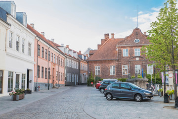 Viborg, Denmark, July 2018: Beautiful street with stone road and old houses with tiled roof