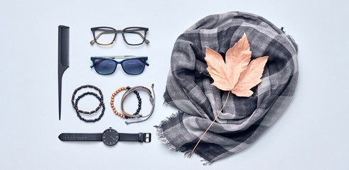 Man accessories Outfit, lifestyle concept. Minimal fashion Creative Flat lay. Trendy Scarf, Stylish male Watch and Sunglasses. Hipster Guy fashionable layout, banner