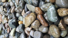 Full Frame Shot Of Wet Pebbles At Shore