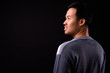 © Ranta Images - Rear view of happy young Asian man thinking and looking up