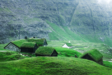 Wall Mural - Summer view of traditional turf-top church Saksunar Kirkja in Saksun village. Beauty landscape with grassy houses and high mountains. Streymoy island, Faroe Islands, Denmark.