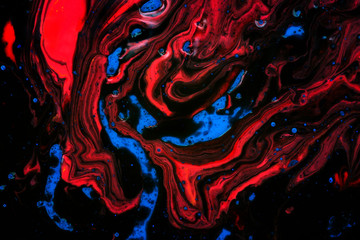 Mixed colors of black, blue and red. Abstract natural texture made of watercolor and oil paints.