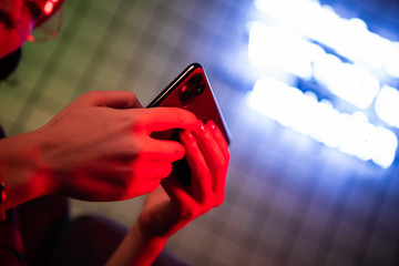 Closeup of Teenager Playing videogames On Mobile phone. Shallow depth of field