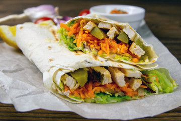 Wall Mural - Homemade shawarma, burrito, chicken roll with vegetables and sauce. Front view ingredients