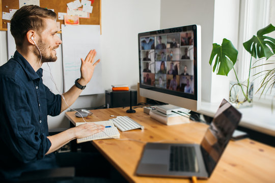 young man having video conferencing call via computer. working remotely managing team virtual call s