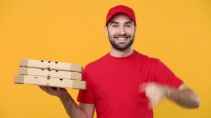 Wall Mural - Delivery guy man in red cap t-shirt uniform workwear hold give order empty cardboard pizza boxes takeaway isolated on yellow background studio Professional male employee work courier Service concept