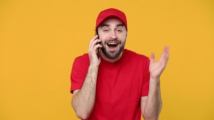 Wall Mural - Delivery young guy man in red cap blank t-shirt uniform workwear using mobile cell phone isolated on yellow background studio Professional male deliveryman employee working as courier Service concept