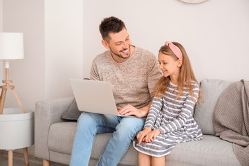 Canvas Print - Father with little daughter video chatting at home